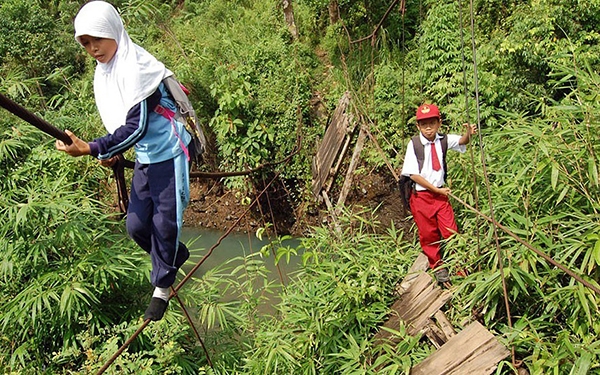 
	
	Ở Sumatra, Indonesia, học sinh phải vượt qua một sợi dây cheo leo cao hơn 9 mét để vượt sông đến trường. Ảnh: Panjalu Images.