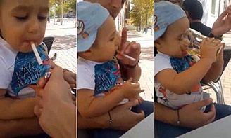 
Hình ảnh cậu bé 1 tuổi được bố cho hút thuốc và uống bia khiến cư dân mạng phẫn nộ. Ảnh: Internet