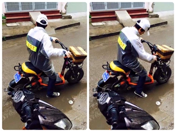 
Hình ảnh H.Đ.C đi xe đạp điện mặc áo mưa có dán chữ C.S.G.T (viết tắt của Cảnh sát giao thông).